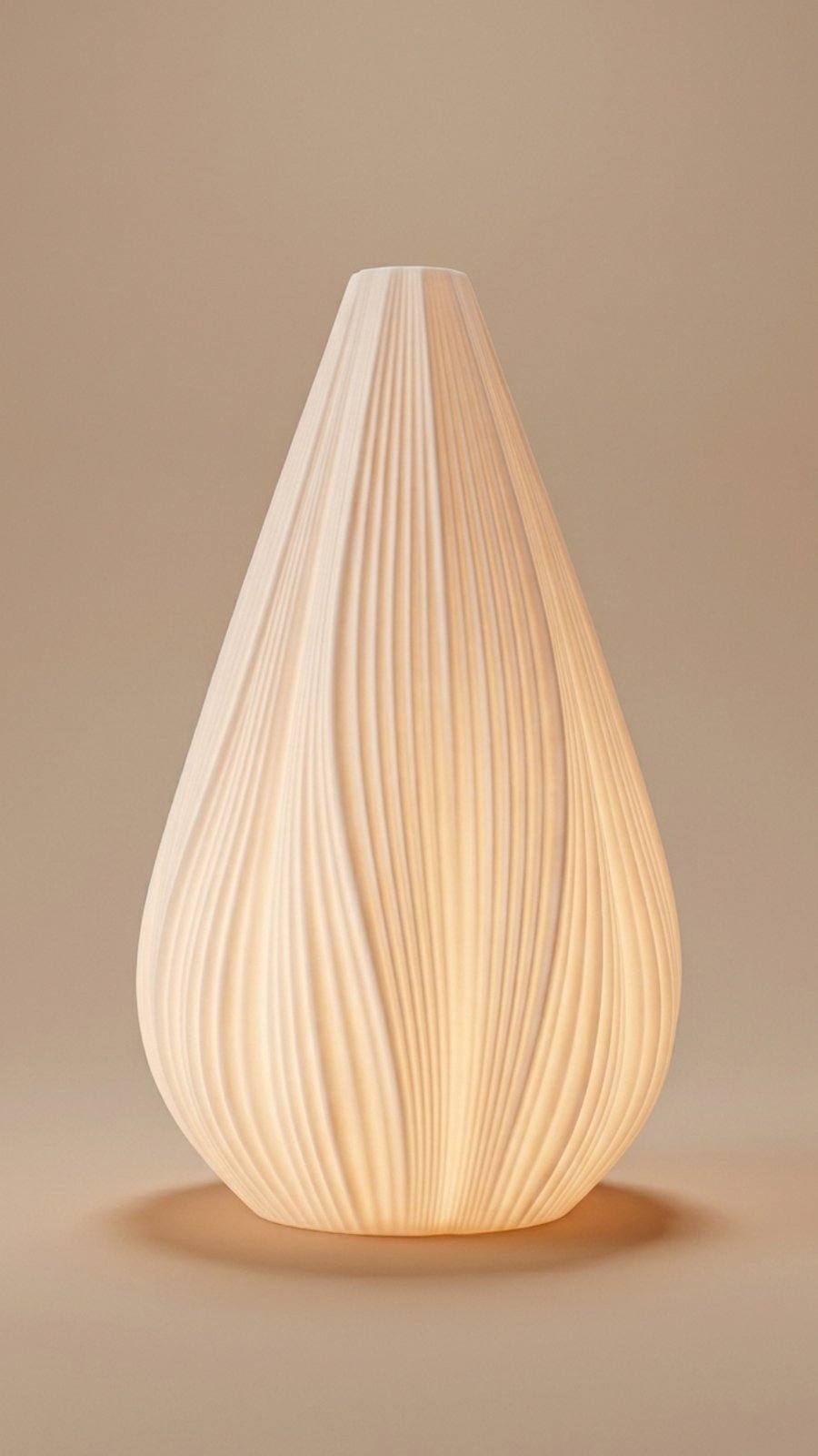 A white ribbed ceramic teardrop-shaped table lamp glowing with warm internal light against a neutral beige background.